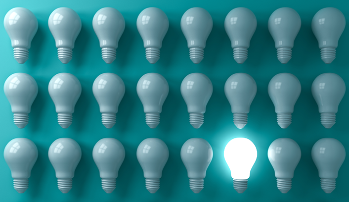 3 rows of 6 lightbulbs on a teal background. All the lightbulbs are unlit except for the second one from the right in the bottom row